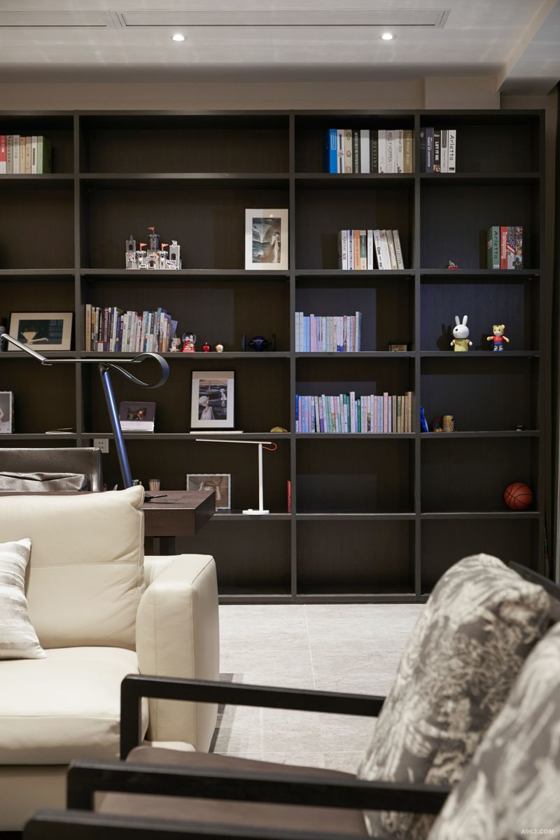 空间摒除了一切的华美细巧的精雕细琢
简单的黑色书柜
反而凸显出一种明朗的情调