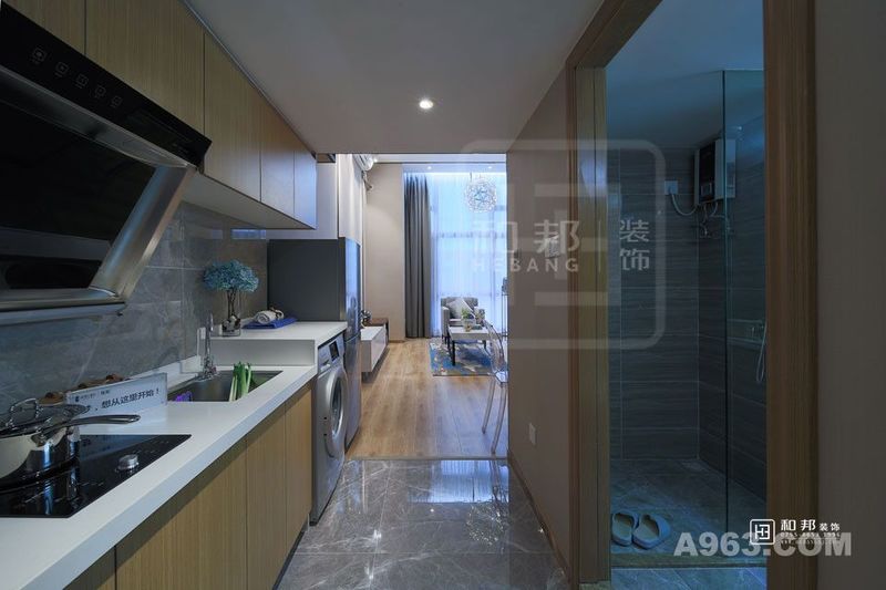 入门即是厨房，灰色系仿大理石纹砖从地面延伸至墙面，搭配白色台面与木色橱柜，营造一种舒适整洁的视觉感受。