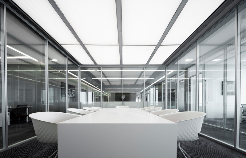 会议室与走廊之间的透明玻璃隔断将两个空间互相连接，既划分了私密空间，满足了使用功能，又不会太过狭隘，从视觉上延展了会议室和走廊的空间。