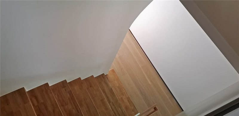 蜿蜒的楼梯，质朴简素，将自然的原木色铺展开来，加之玻璃的通透材质，让人在视线上毫无阻碍，连接并勾勒出空间丰富立体的层次。