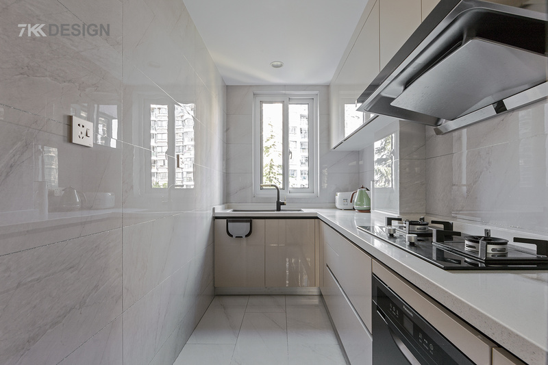 厨房L型转角设计，橱柜选用浅木色系橱柜，搭配白色墙砖，使得整个空间的都非常干净整洁，L型的烹饪台面宽敞操作舒适。 