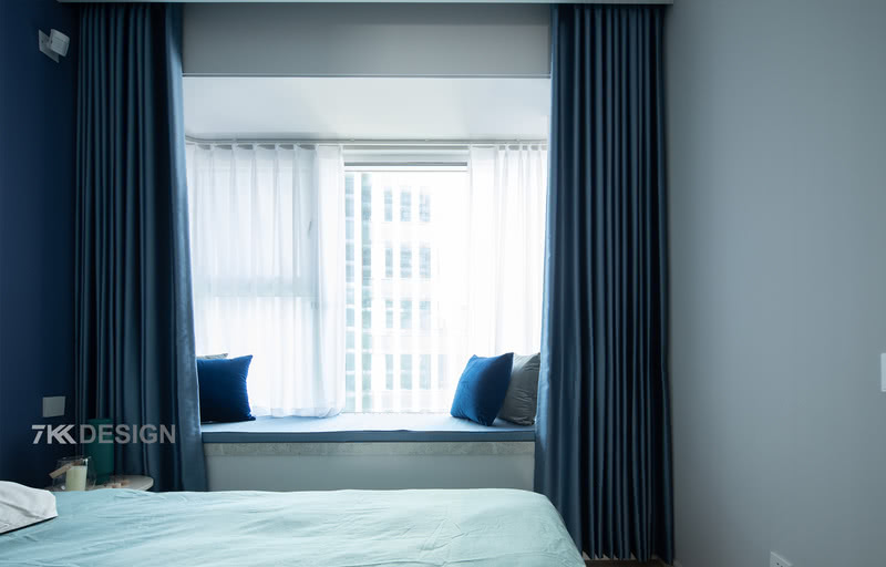 飘窗外侧是一层白色的窗纱，内部是厚实的蓝色窗帘，白天一层窗纱光线透过窗纱演绎空灵舒适的氛围，夜晚拉上蓝色的窗帘，享受安详静谧的睡眠时间。