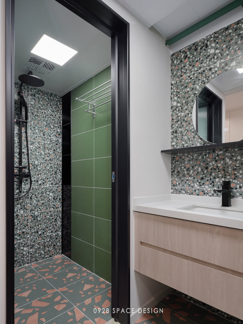 淋浴区同样以墨绿色和花色瓷砖为主，细纹花色瓷砖作为淋浴的背景墙，墙面包管以后正好形成壁龛作为储物，用黑色不锈钢饰面，让复古的空间中多了一点现代精致感。