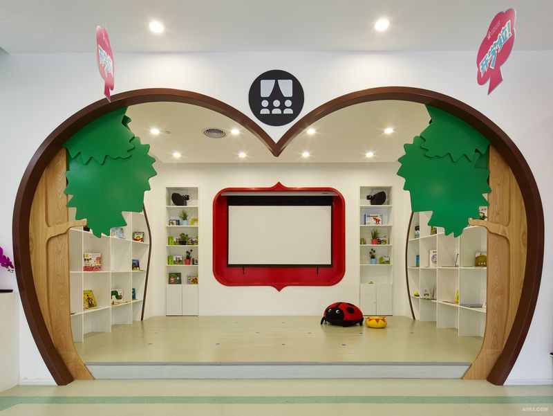 充满童话气息的门框隔断，
将动态空间与静态空间有趣的区分，
造型独特的苹果边框与扁平化的绿色植物，
给孩子们提供一个趣味十足的阅读空间。