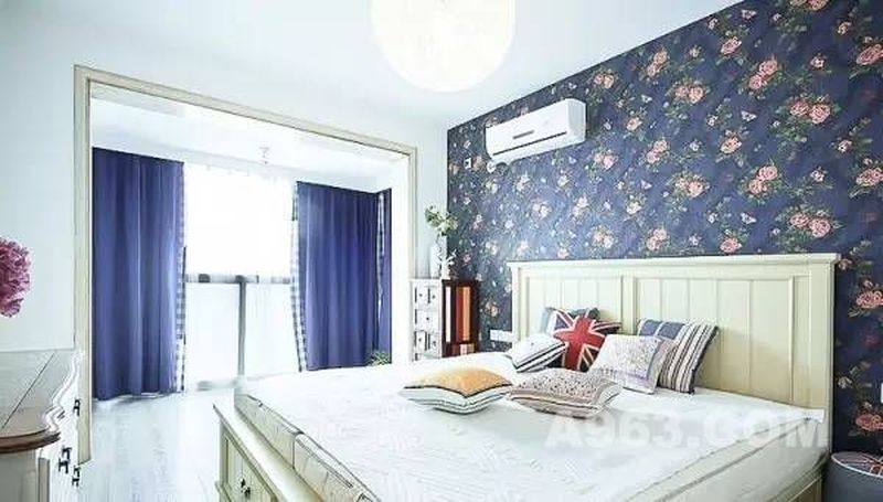▲蓝色的窗帘和床头背景墙的壁纸相呼应，宁静的氛围中加入粉色的花朵，给卧室注入自然气息。