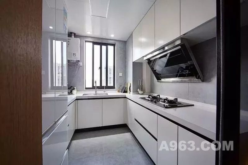 白色橱柜让厨房看起来明亮宽敞，浅灰色的地砖和墙砖则增加了空间的质感。