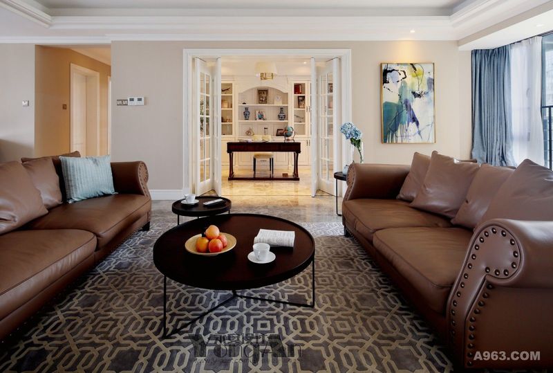 客厅：舒适的皮质沙发，大小不一的茶几，简单而和谐。