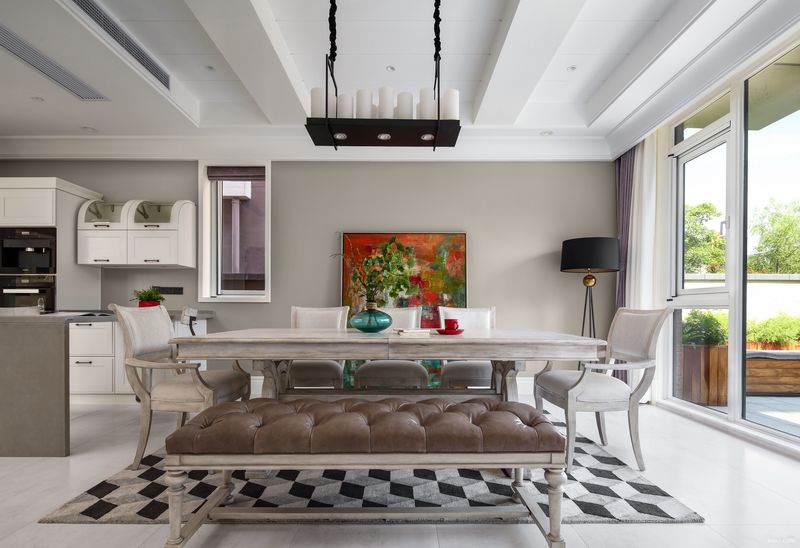 小美式的家具，以灰白为主色调，桌上的装饰和色彩鲜亮的背景画为安静的空间增添了一份活跃的感觉。